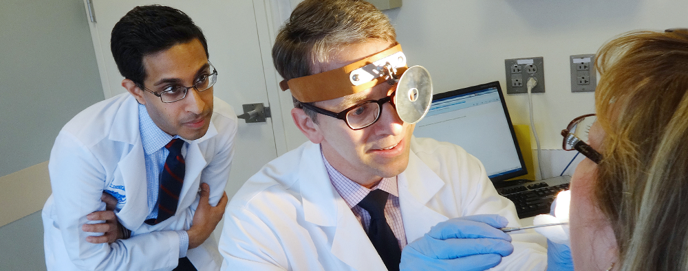 Otolaryngology physician and fellow examine a patient