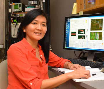 dr heidi nakajima at a microscope